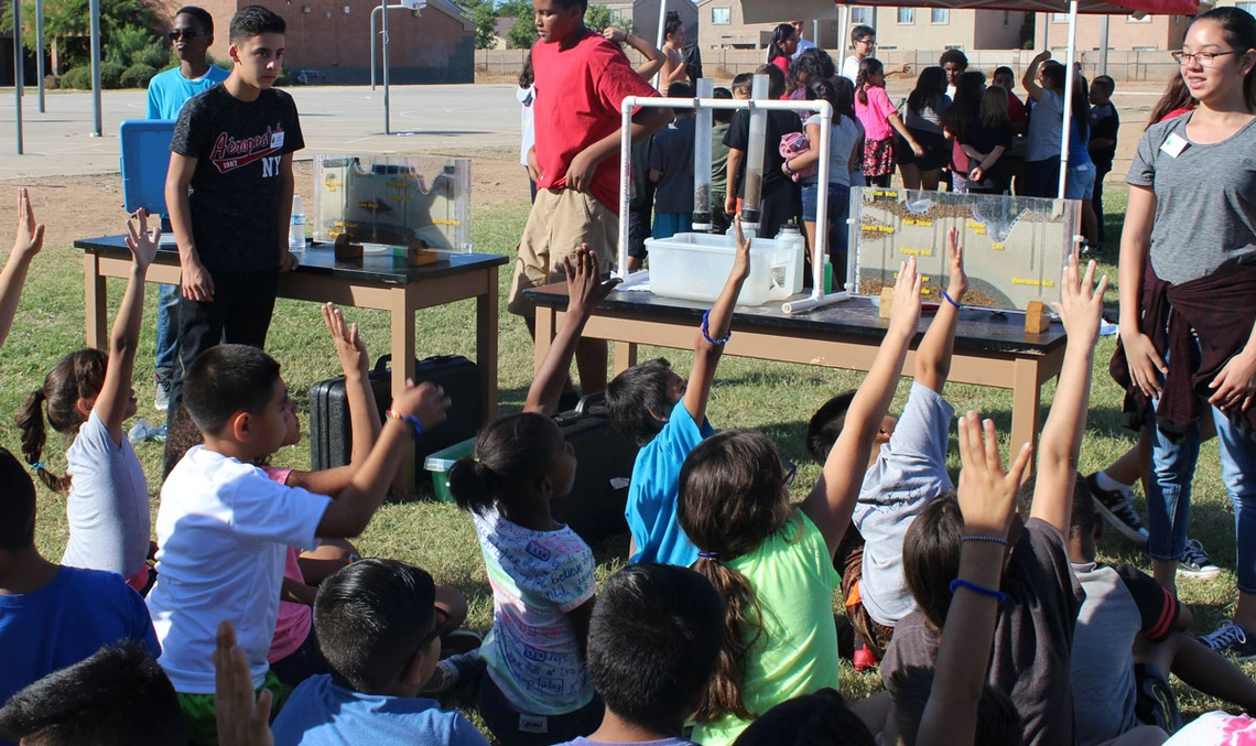 Arizona Project WET- Paying it Forward students raising hands to ask questions in an apw event