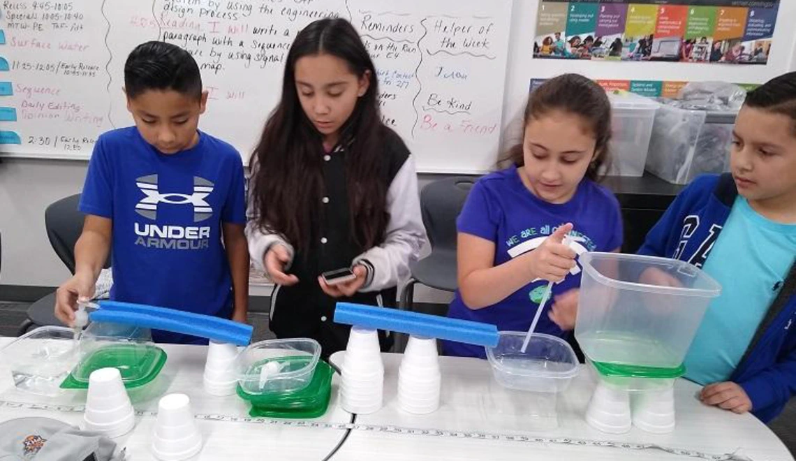 Children doing water experiment Children doing water experiment