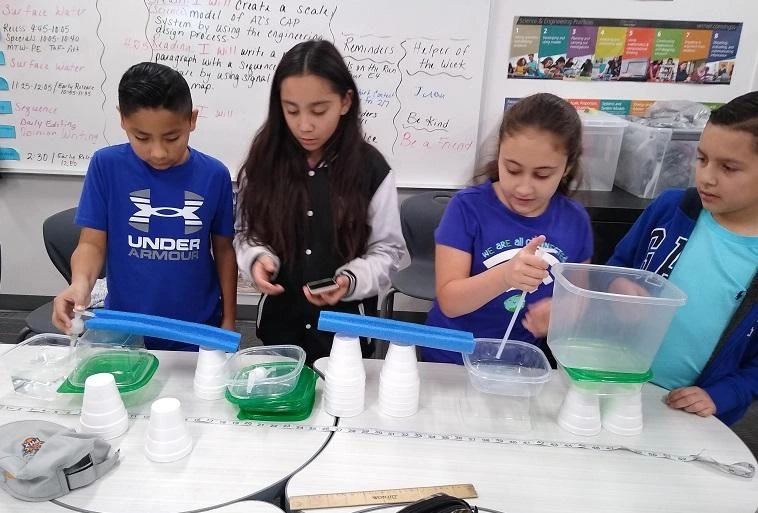 Children doing water experiment Children doing water experiment